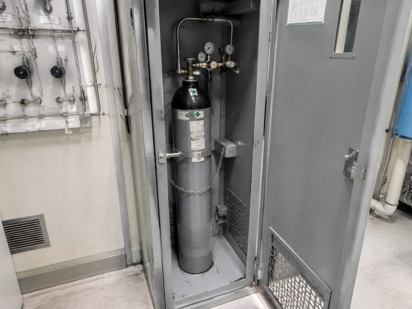 Dichlorosilane cylinder secured inside a ventilated semiconductor gas cabinet.