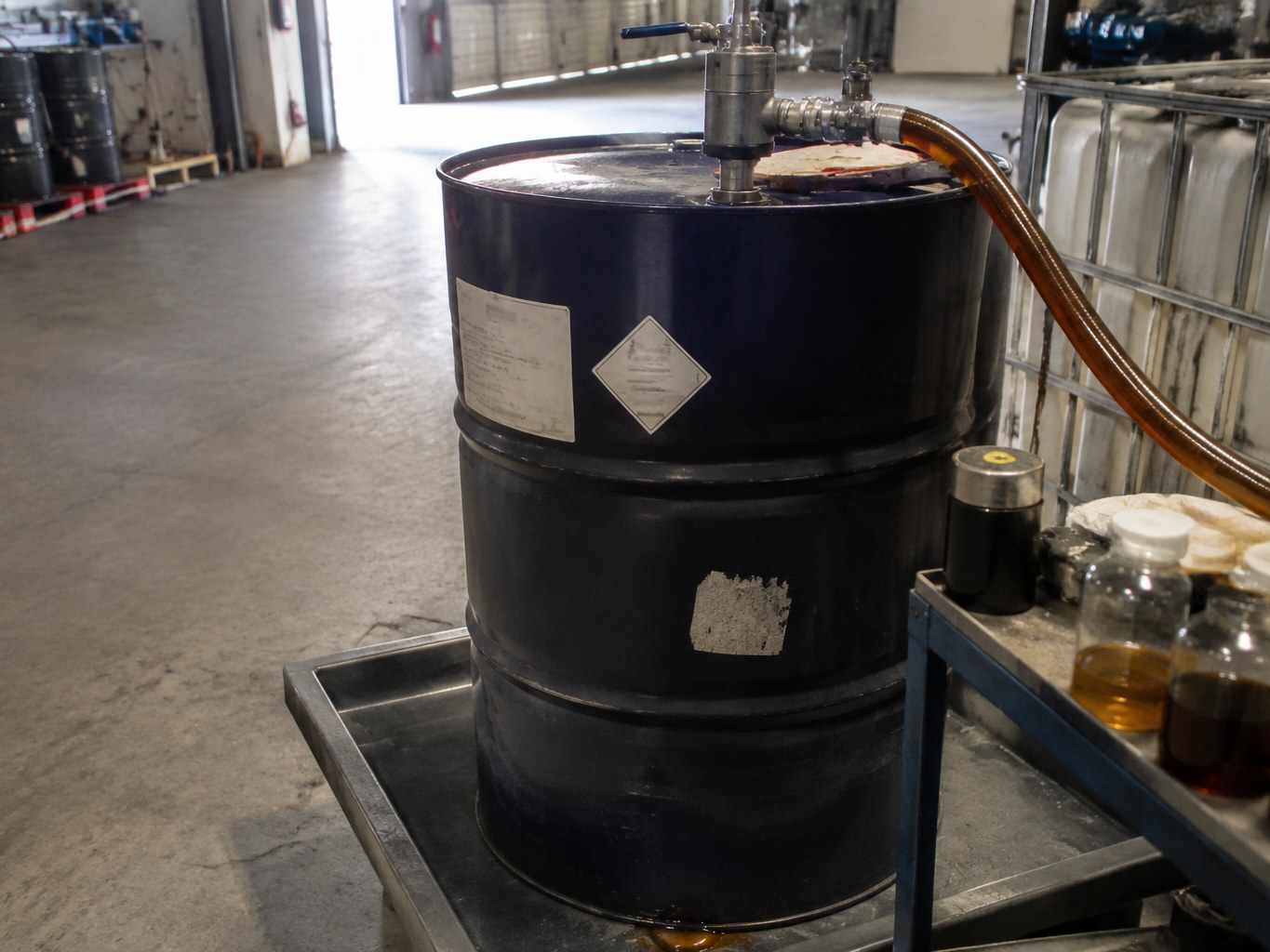 Pumped drum of amber magnesium petroleum sulfonate in a lubricant blending area.