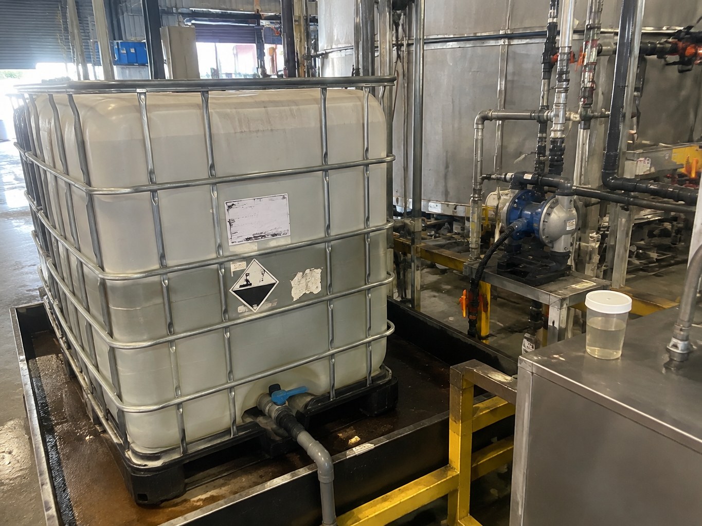 Polyamide-epichlorohydrin resin IBC connected to paper-mill chemical dosing equipment.