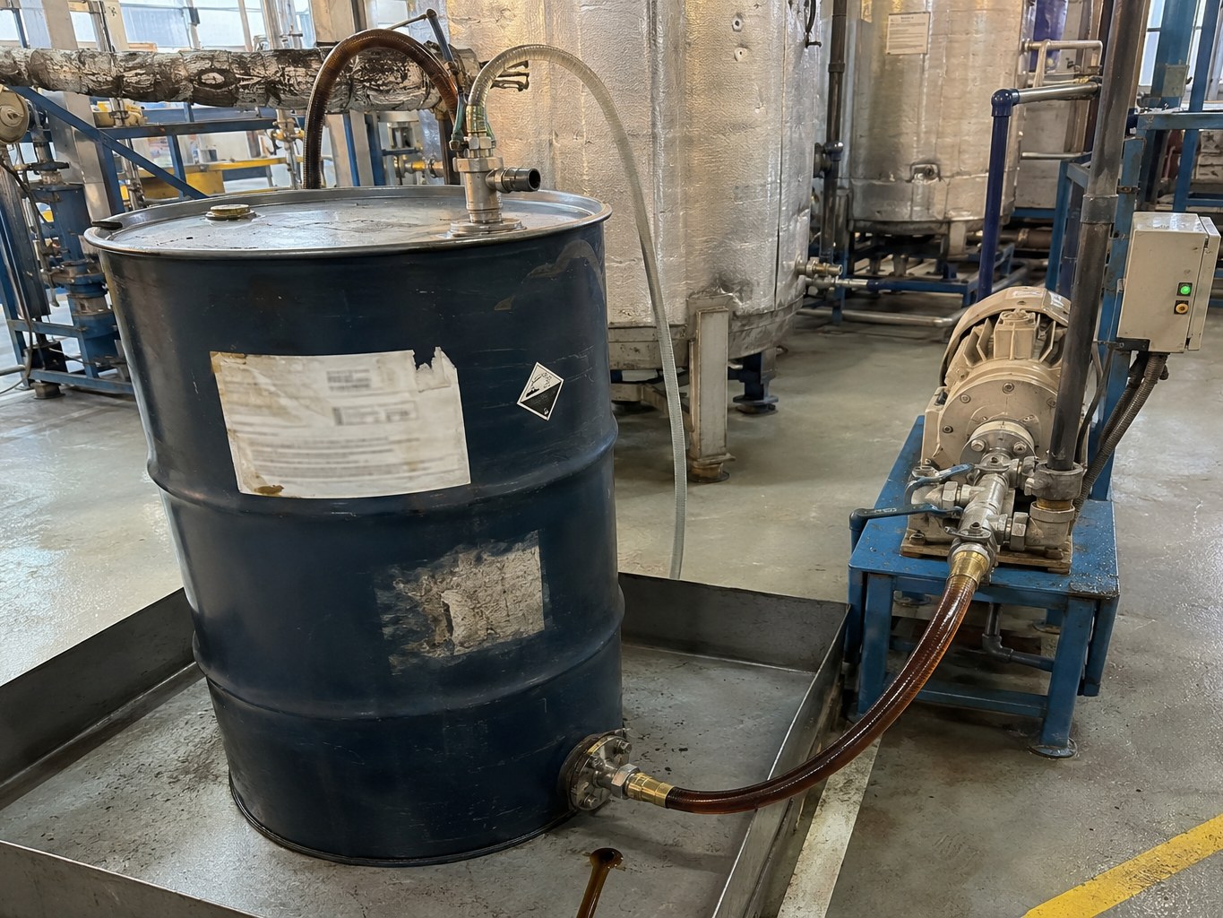 Heated drum of viscous PIBSA connected to transfer equipment in an additive plant.