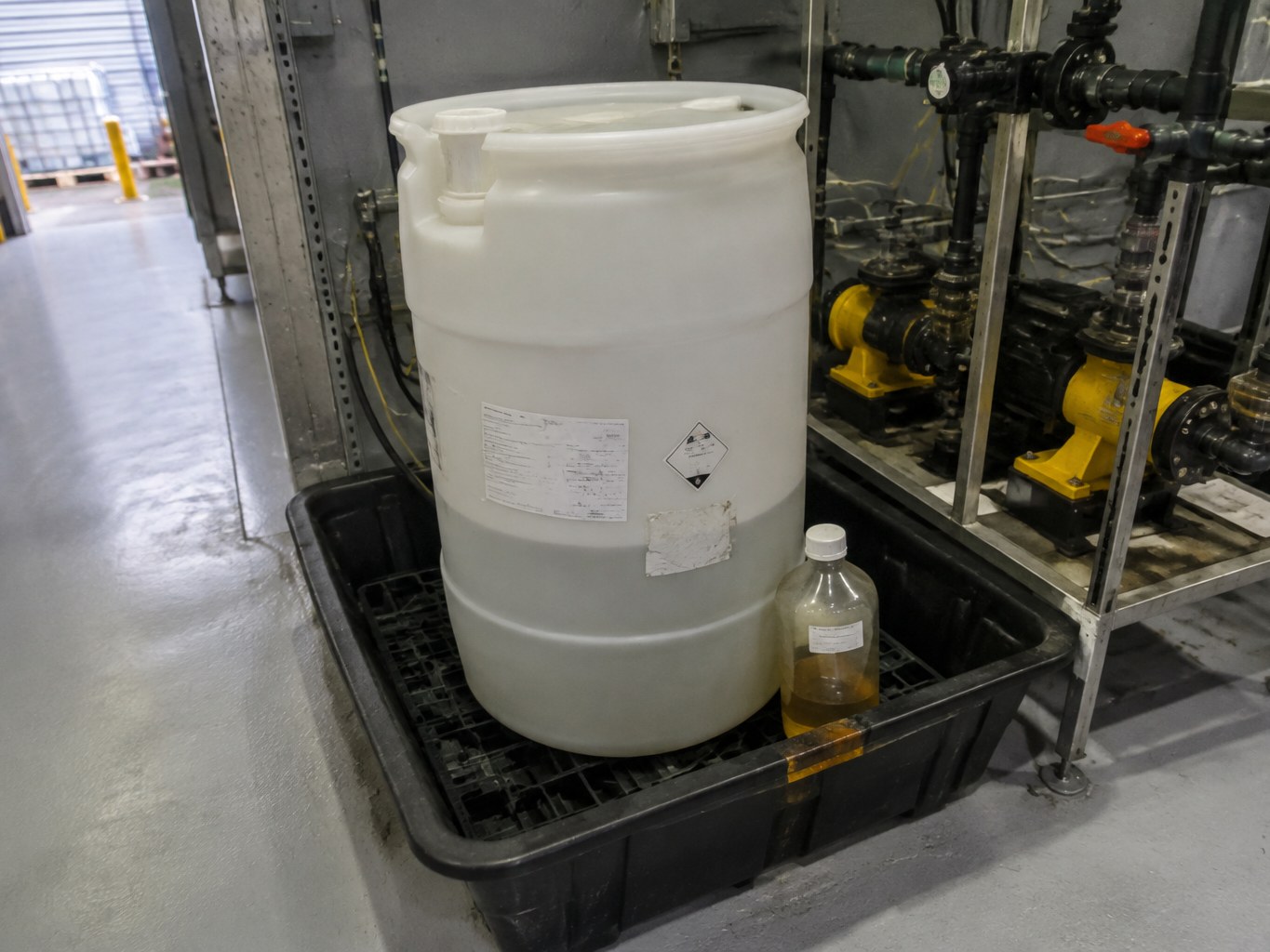 Sodium diisobutyl dithiophosphate solution drum beside flotation reagent dosing equipment.